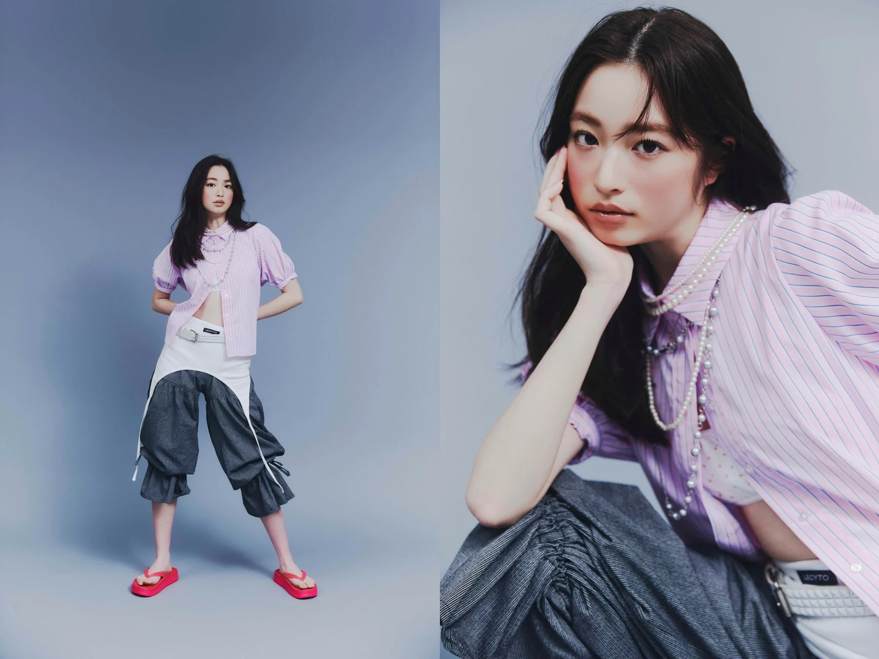 スタジオで撮影された、ストライプのピンクシャツとユニークなパンツを着用した若い女性モデルのポートレート。パールネックレスが特徴的で、カジュアルながらもスタイリッシュな印象を与えています。