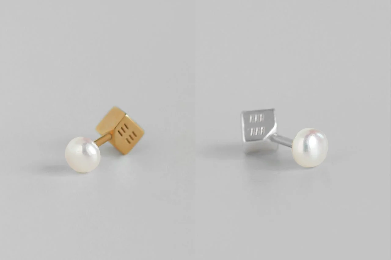 金と銀のキューブ型スタッドに真珠が付いたピアス